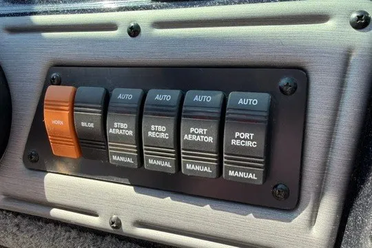 Slide: The Image of Control panel of a 2018 Ranger VS1670 SC boat with various switches. - 15