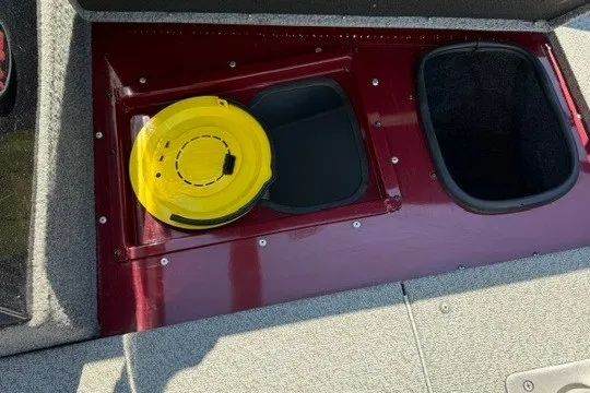 Slide: The Image of 2018 Ranger VS1670 SC boat storage compartment with yellow lid and carpeted interior. - 29