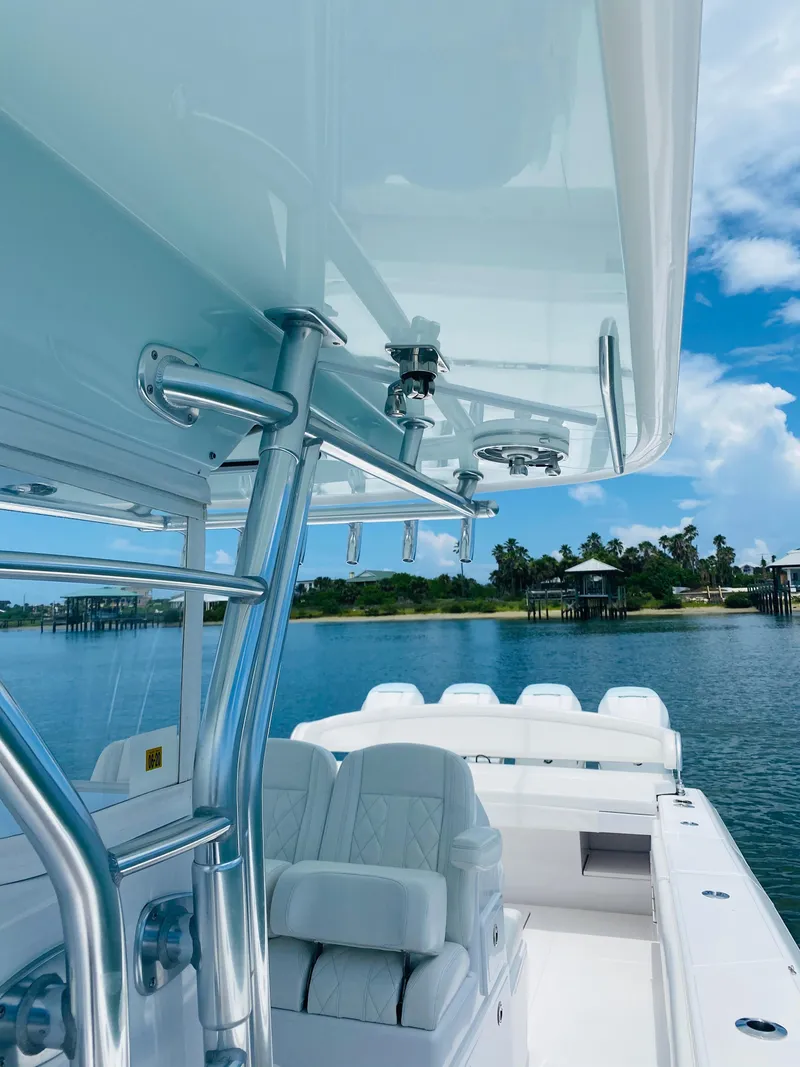 Slide: The Image of The image shows the cockpit of a 2019 Bahama 41 boat with white seats and blue sky. - 17