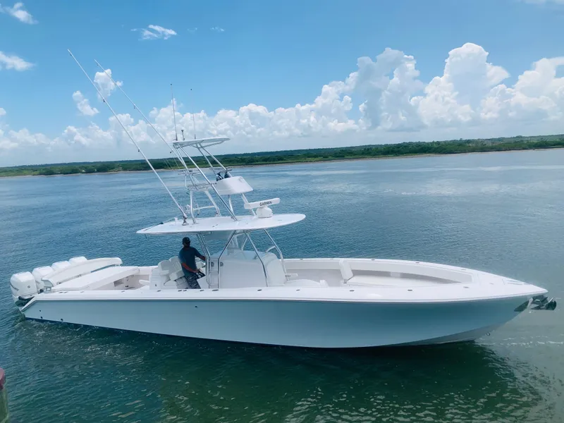 The Image of A sleek white boat on calm water with a clear sky in the background. - 1