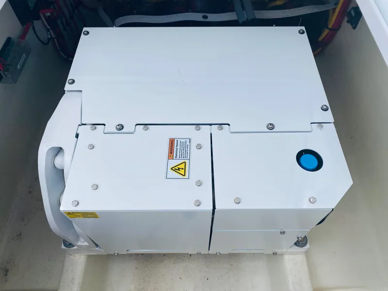 Slide: The Image of A white generator is installed in a boat, surrounded by cables and switches. - 20