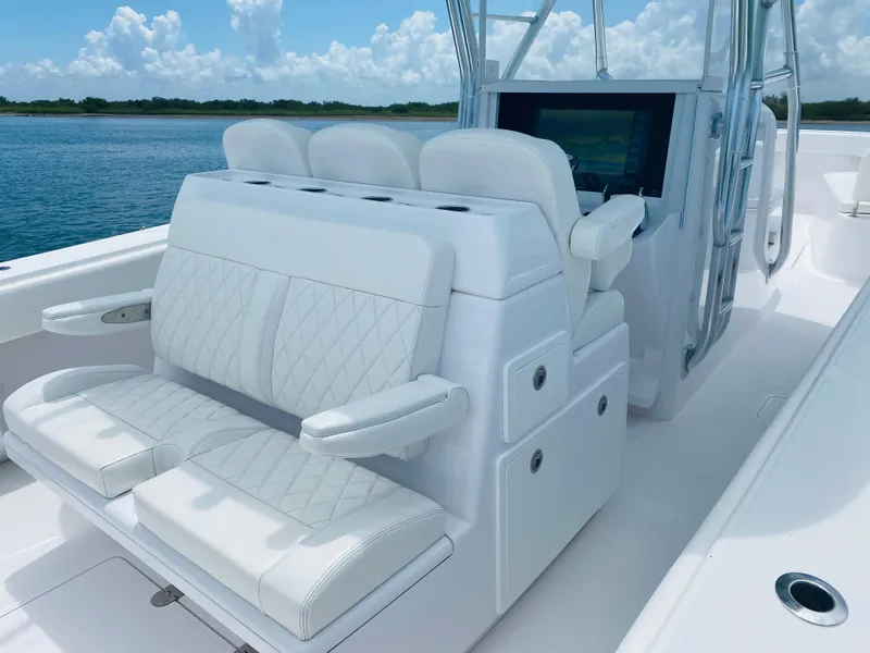 Slide: The Image of The image shows the cockpit of a 2019 Bahama 41 boat with white upholstered seats. - 18