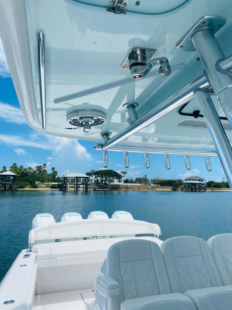 Slide: The Image of The image shows the cockpit of a 2019 Bahama 41 boat with white seats and a blue sky. - 16