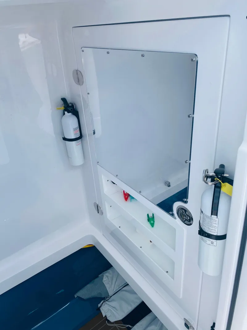 Slide: The Image of The image shows a white boat interior with fire extinguishers and an empty window frame. - 15
