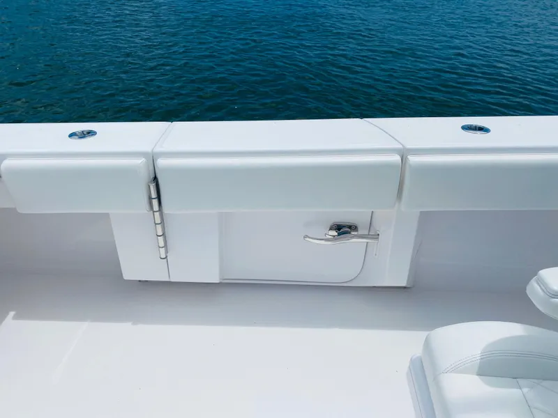 Slide: The Image of The image shows the white deck of a 2019 Bahama 41 boat with a blue water background. - 19