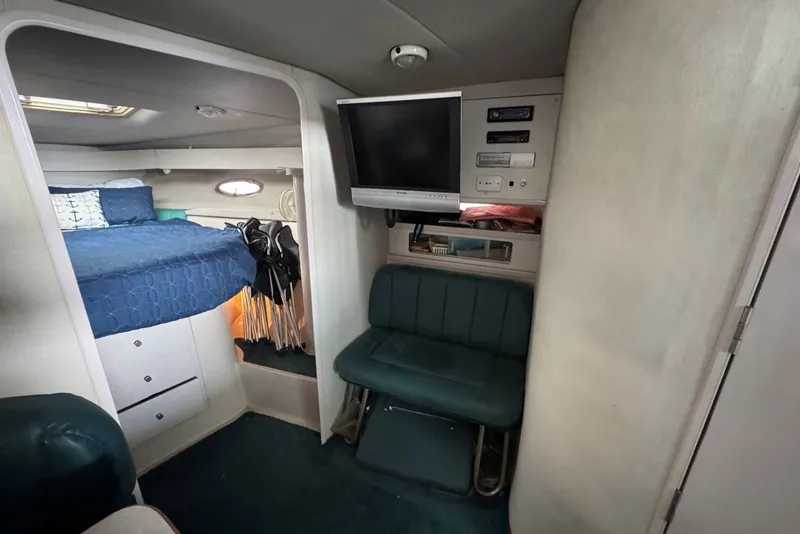 Slide: The Image of Interior of 1994 Regal Commodore 400 boat with bed, TV, and seating area. - 24