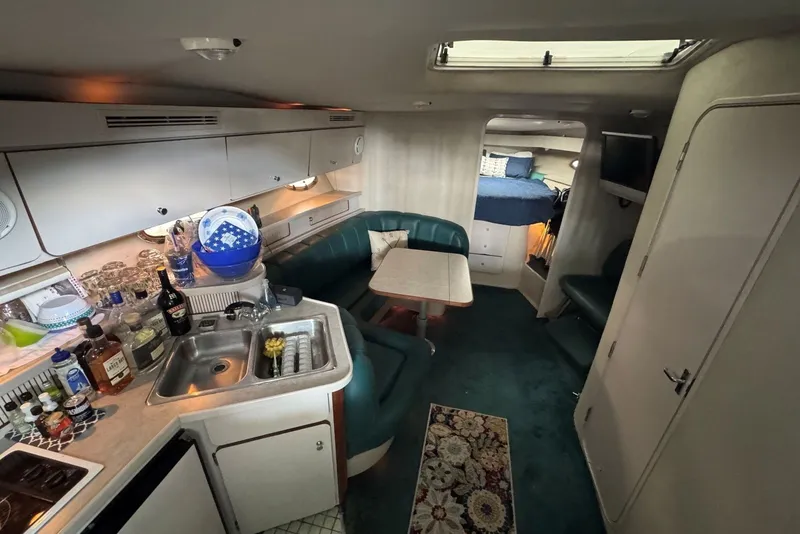 Slide: The Image of Interior of a 1994 Regal Commodore 400 yacht with kitchen and seating area. - 21