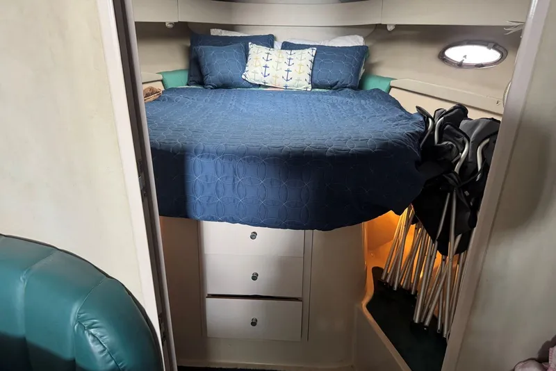 Slide: The Image of Cozy cabin interior of 1994 Regal Commodore 400 with blue bedding and storage space. - 25
