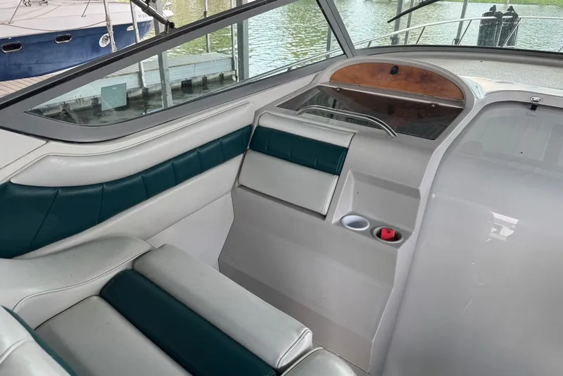 Slide: The Image of Interior of a 1994 Regal Commodore 400 boat with green and white seating. - 17