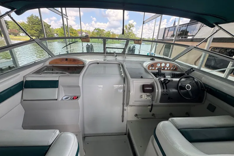 Slide: The Image of Cockpit of 1994 Regal Commodore 400 boat with steering wheel and control panel. - 16