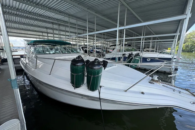 Slide: The Image of 1994 Regal Commodore 400 boat docked in a covered marina. - 10