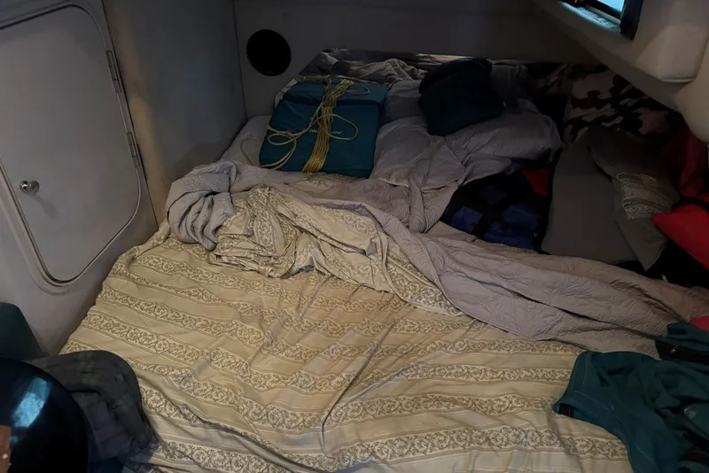 Slide: The Image of Cozy cabin interior of 1994 Regal Commodore 400 with bedding and storage. - 37