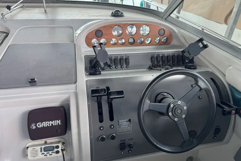 Slide: The Image of Control panel of a 1994 Regal Commodore 400 boat with steering wheel and gauges. - 18