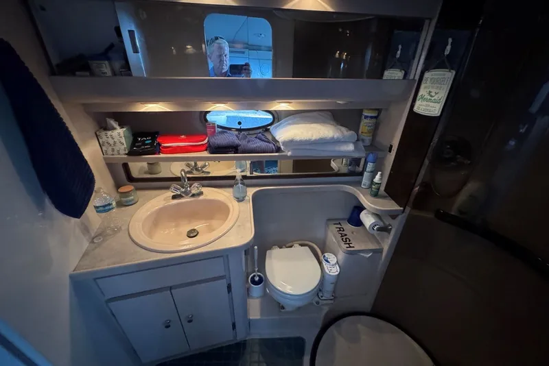 Slide: The Image of Bathroom interior of a 1994 Regal Commodore 400 yacht, featuring sink and toilet. - 33