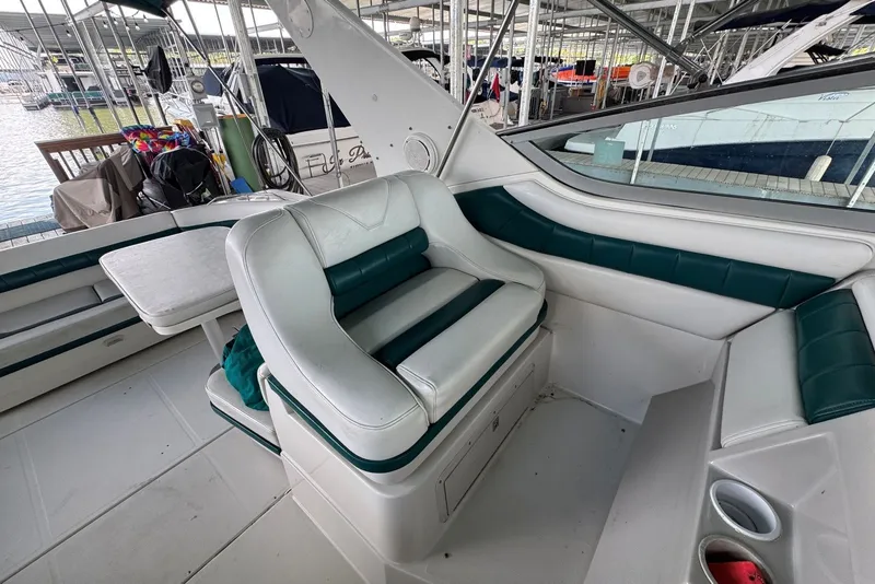 Slide: The Image of Interior of a 1994 Regal Commodore 400 boat with white and green seating. - 15