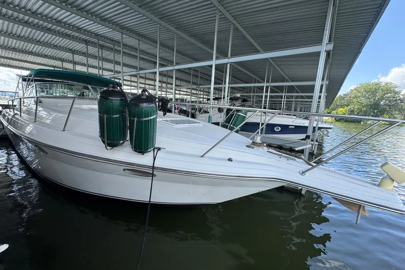 Slide: The Image of 1994 Regal Commodore 400 boat docked under a covered marina. - 9