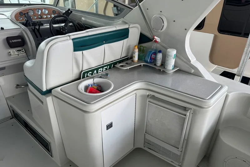 Slide: The Image of 1994 Regal Commodore 400 boat interior with helm, dashboard, and kitchenette area. - 14