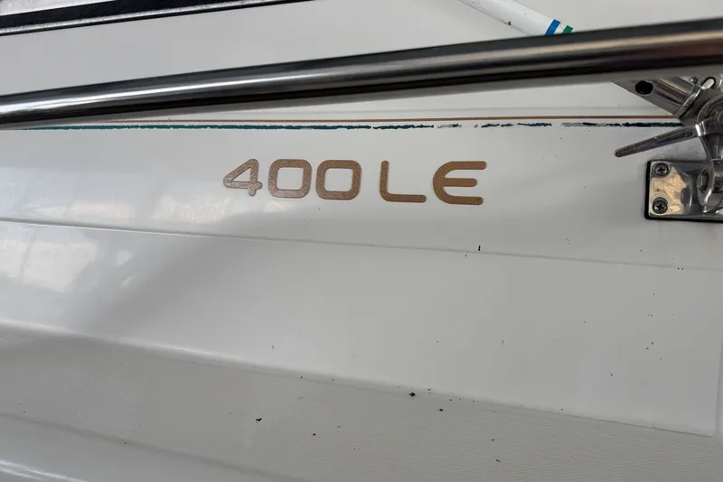 Slide: The Image of 1994 Regal Commodore 400 LE boat detail with metal railing and logo. - 12