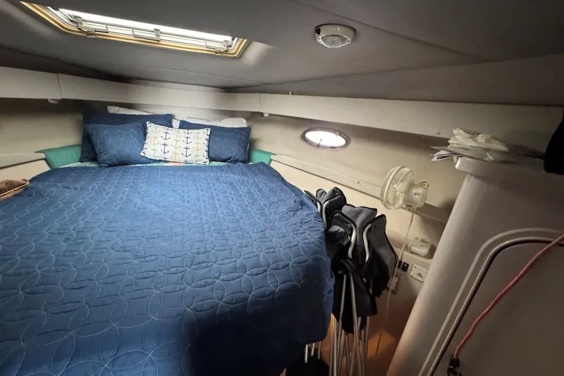 Slide: The Image of Cozy cabin interior of 1994 Regal Commodore 400 with blue bedding and nautical decor. - 30