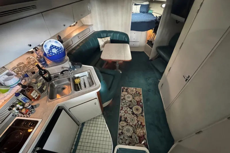 Slide: The Image of Interior of a 1994 Regal Commodore 400 yacht with kitchen and seating area. - 22