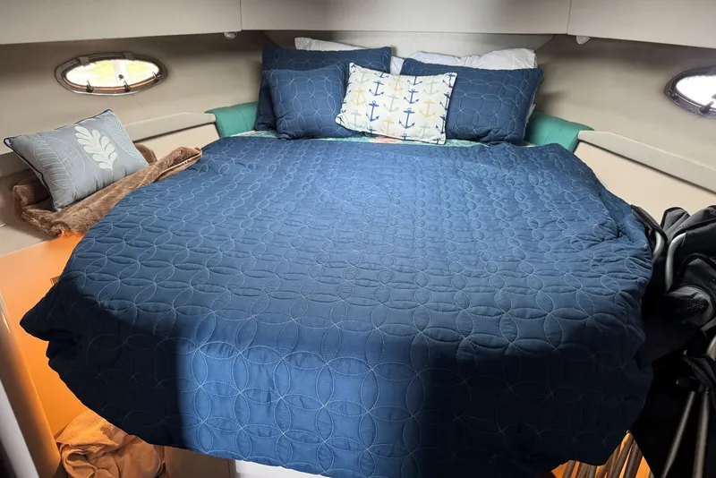 Slide: The Image of Cozy cabin bed in 1994 Regal Commodore 400 yacht with nautical-themed pillows. - 26
