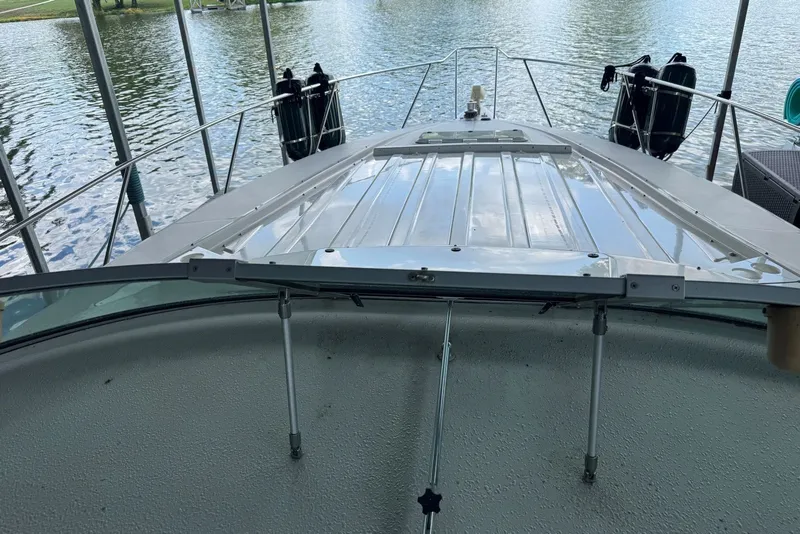 Slide: The Image of 1994 Regal Commodore 400 boat docked on a calm lake. - 20