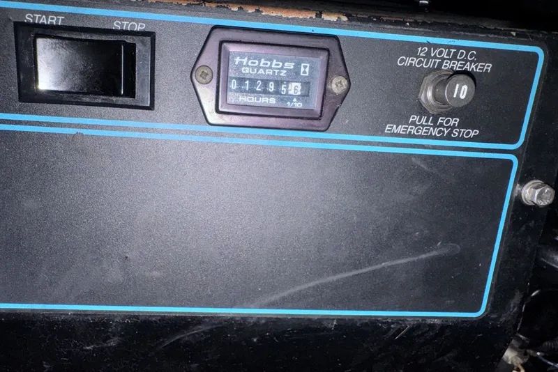 Slide: The Image of Control panel of a 1994 Regal Commodore 400 with hour meter and circuit breaker. - 44