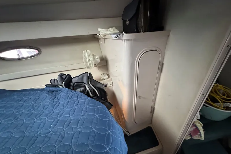 Slide: The Image of Interior of 1994 Regal Commodore 400 boat cabin with bed and storage. - 27