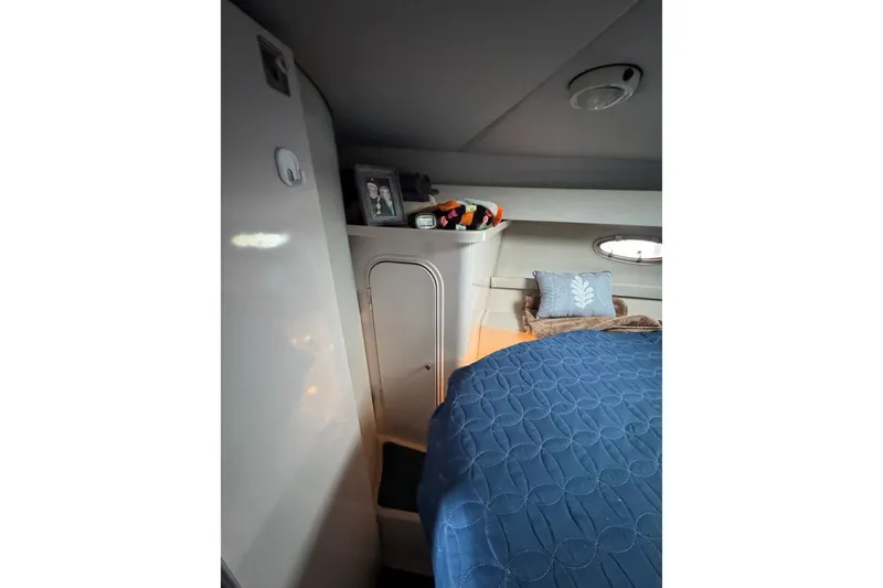 Slide: The Image of Interior cabin of 1994 Regal Commodore 400 with blue bedding and decorative pillows. - 28