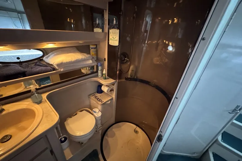 Slide: The Image of 1994 Regal Commodore 400 bathroom with shower, sink, and storage shelves. - 34