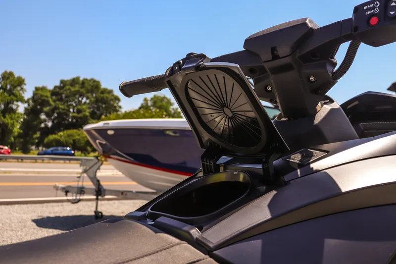 Slide: The Image of 2025 Yamaha WaveRunner GP HO with open storage compartment, parked near a boat. - 14