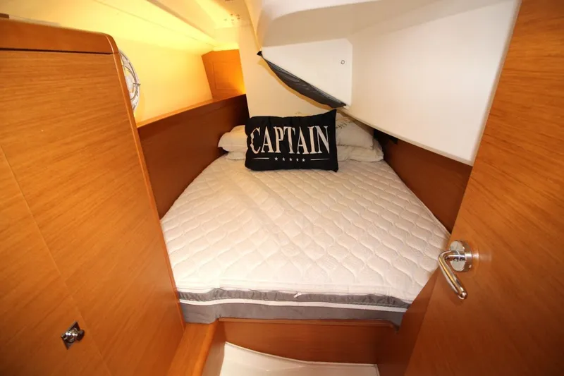 Slide: The Image of Cozy cabin interior of 2015 Jeanneau Sun Odyssey 349 sailboat with captain-themed pillow. - 26