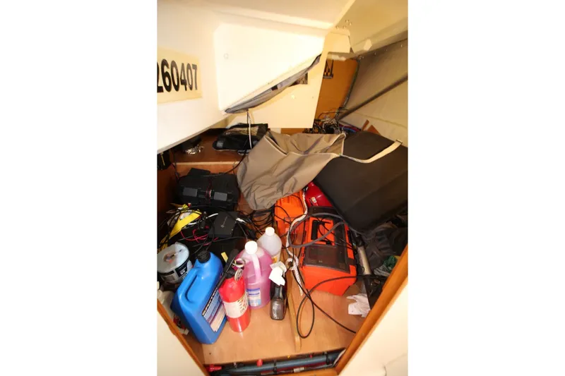 Slide: The Image of Storage area of a 2015 Jeanneau Sun Odyssey 349 sailboat with various equipment and supplies. - 29