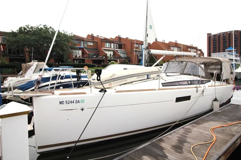 Slide: The Image of 2015 Jeanneau Sun Odyssey 349 sailboat docked in a marina, surrounded by other boats. - 4