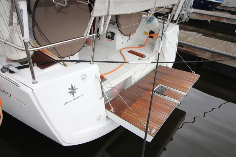Slide: The Image of Jeanneau Sun Odyssey 349, 2015 model, featuring a wooden swim platform at the stern. - 14