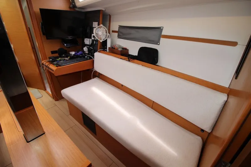 Slide: The Image of Interior of 2015 Jeanneau Sun Odyssey 349 yacht with modern seating and navigation equipment. - 24