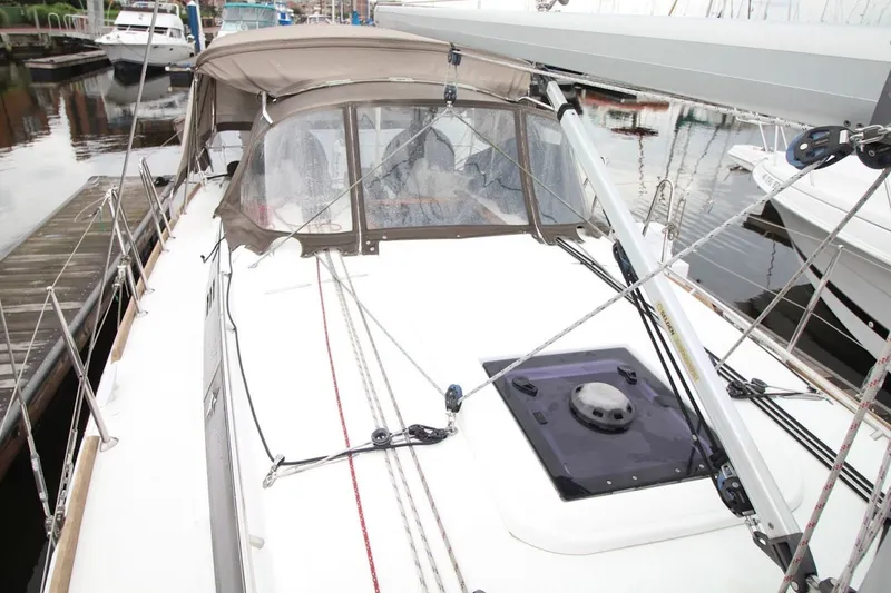 Slide: The Image of 2015 Jeanneau Sun Odyssey 349 sailboat docked, showcasing deck and rigging details. - 13