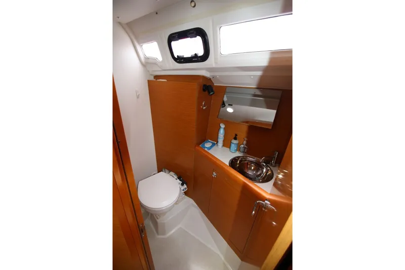 Slide: The Image of Bathroom interior of 2015 Jeanneau Sun Odyssey 349 yacht, featuring toilet and sink. - 27