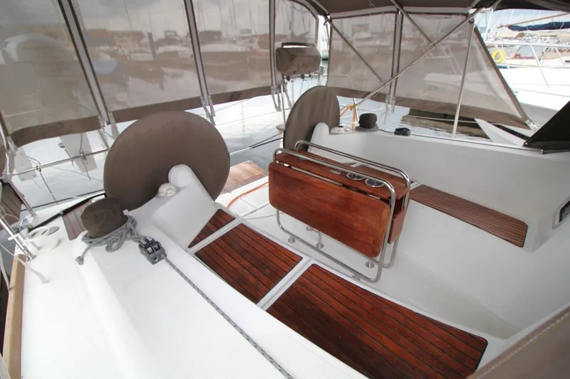 Slide: The Image of 2015 Jeanneau Sun Odyssey 349 cockpit with wooden seating and covered helm. - 15