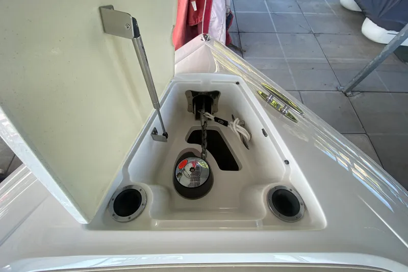 Slide: The Image of Open storage compartment on 2010 Cobalt 302 boat, featuring anchor and rope. - 37