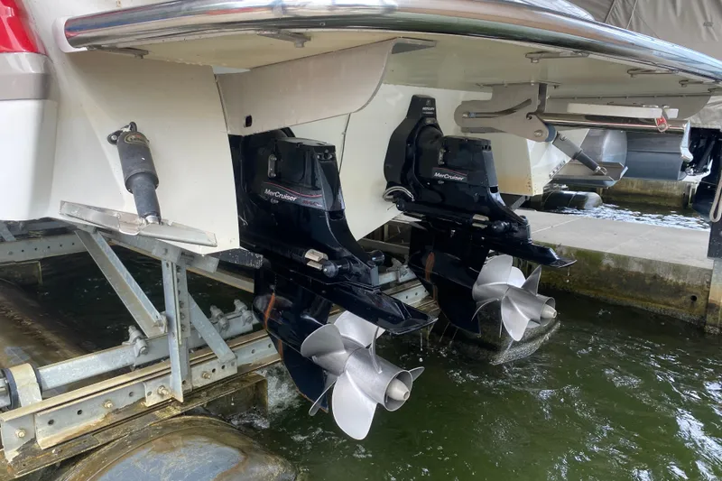 Slide: The Image of Rear view of a 2010 Cobalt 302 boat with dual MerCruiser outdrives. - 48