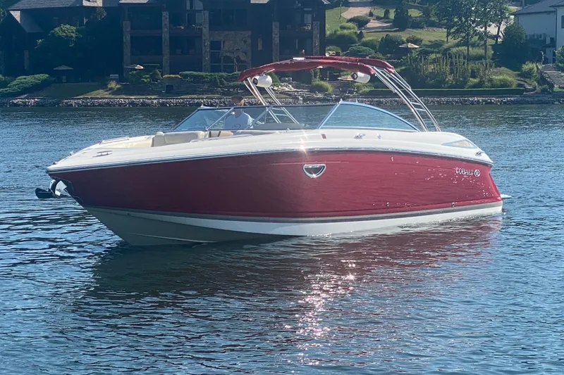 Slide: The Image of Red 2010 Cobalt 302 boat on a serene lake with scenic background. - 4