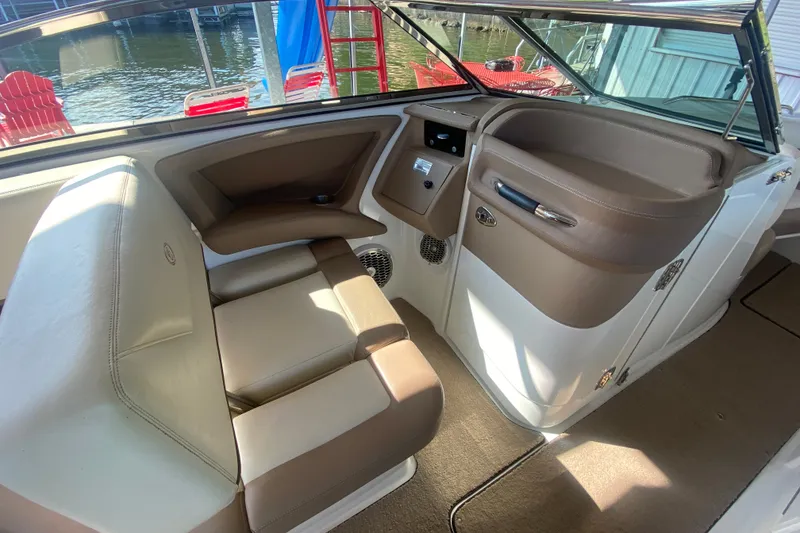 Slide: The Image of Interior of a 2010 Cobalt 302 boat with beige and brown seating. - 25