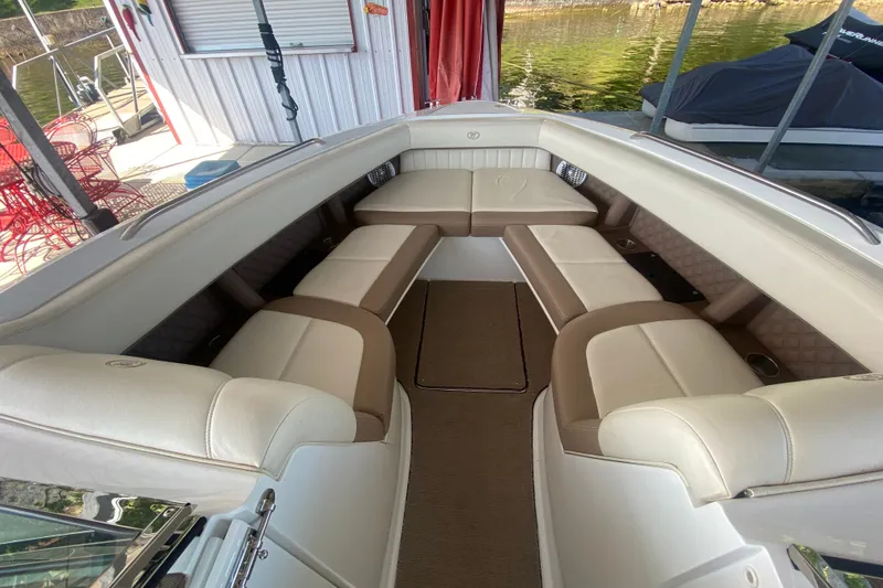 Slide: The Image of 2010 Cobalt 302 boat interior with beige seating and carpeted floor. - 33