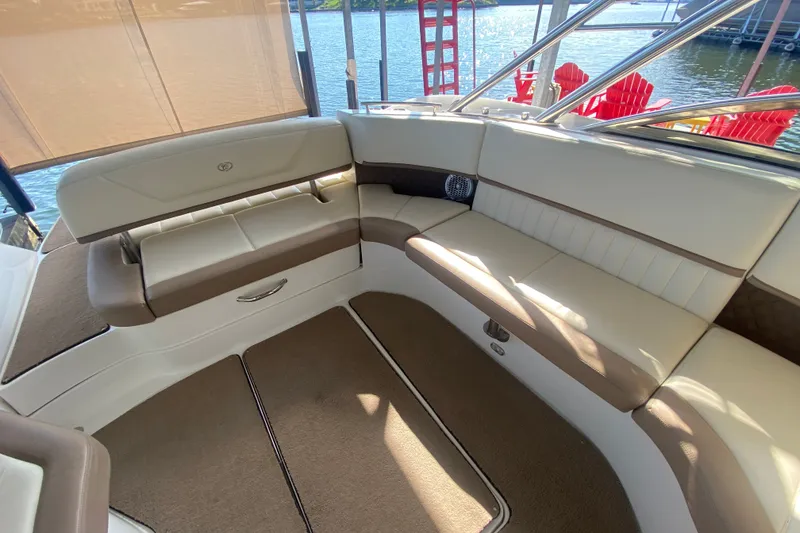 Slide: The Image of Luxurious seating area on a 2010 Cobalt 302 boat, featuring beige and brown upholstery. - 14