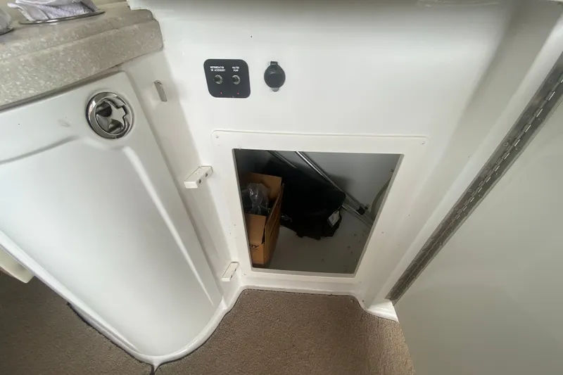 Slide: The Image of Interior storage compartment of a 2010 Cobalt 302 boat with control panel. - 19