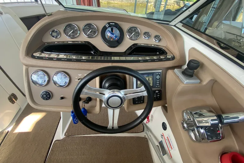 Slide: The Image of Steering console of a 2010 Cobalt 302 boat with gauges and controls. - 32