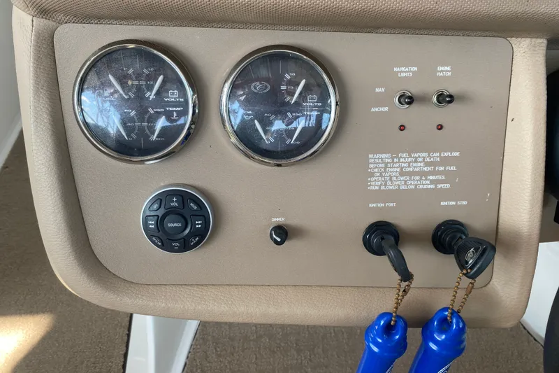 Slide: The Image of Control panel of a 2010 Cobalt 302 boat with gauges and switches. - 5