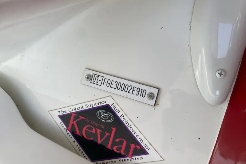 Slide: The Image of 2010 Cobalt 302 boat hull identification number and Kevlar reinforcement label. - 52