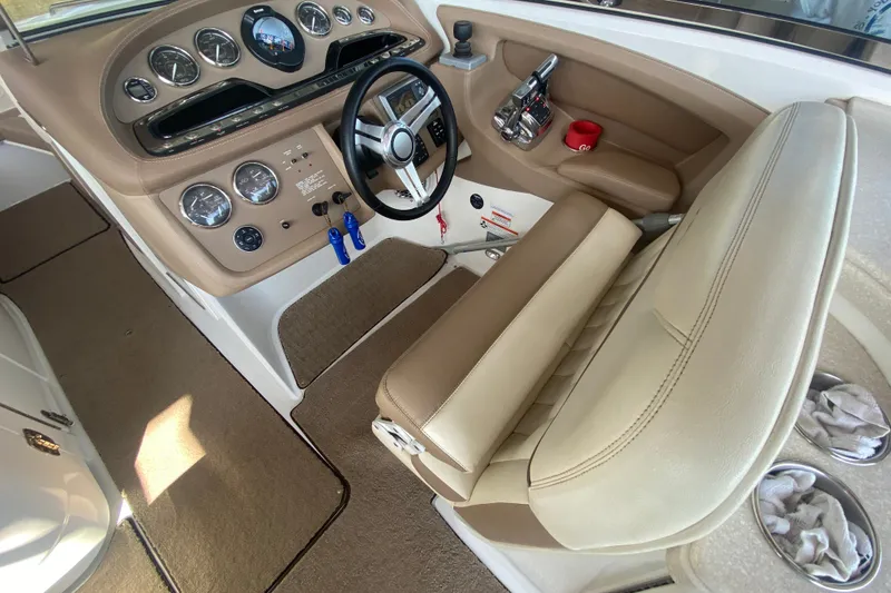 Slide: The Image of Interior of a 2010 Cobalt 302 boat showing steering wheel and dashboard controls. - 18